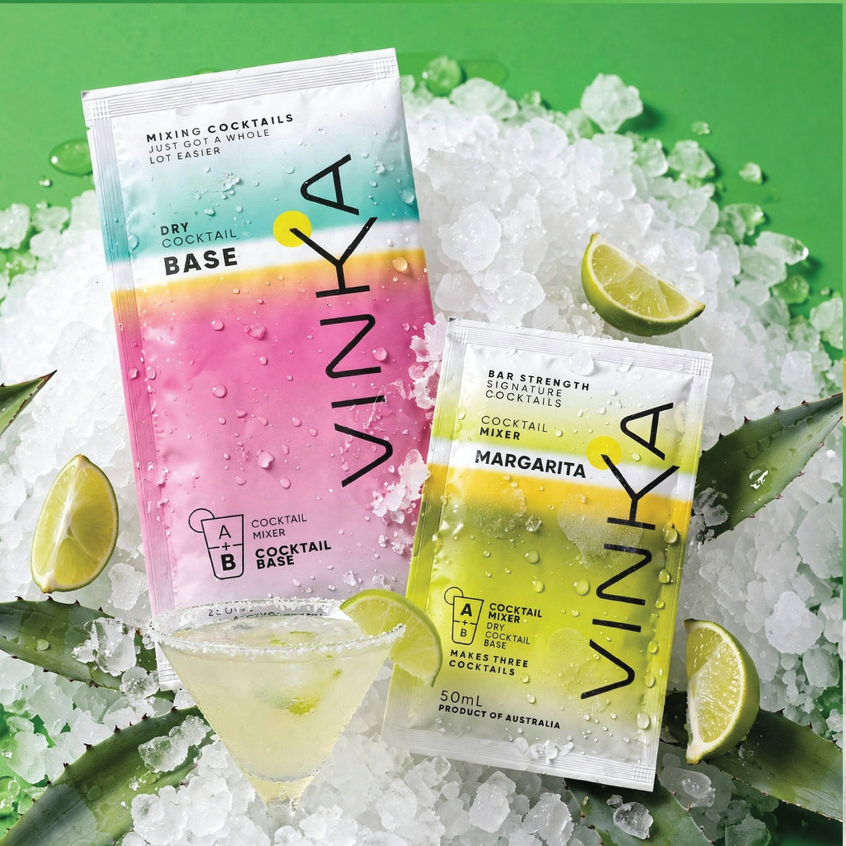 Two VINKA cocktail base packets, one labeled Dry Cocktail Base and one labeled Margarita Bar Strength Cocktail Mixer, displayed on crushed ice with lime wedges and a cocktail glass on a bright green background.