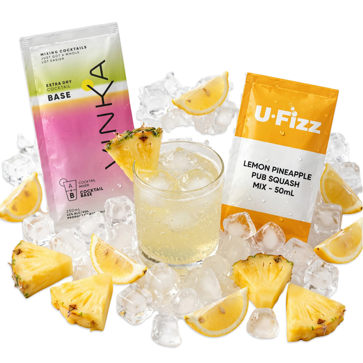 Two packets of VINKA and U-FIzz on ice surrounding a glass of Lemon Pineapple Pub Squash heavily carbonated. Scattered lemon wedges and pineapple chunks everywhere.