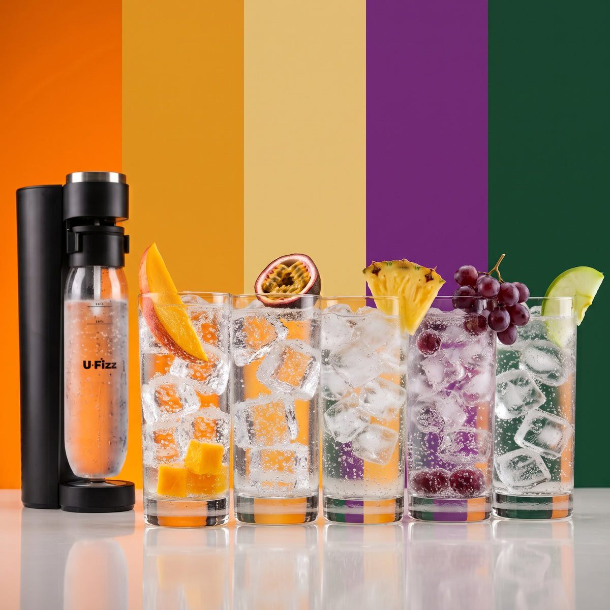 A U-Fizz carbonation bottle and four tall glasses of iced seltzers (1 of each flavour) with fruit garnishes, arranged on a reflective surface.